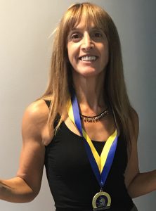 Interview With The Ultra Runner - woman showing off her medal