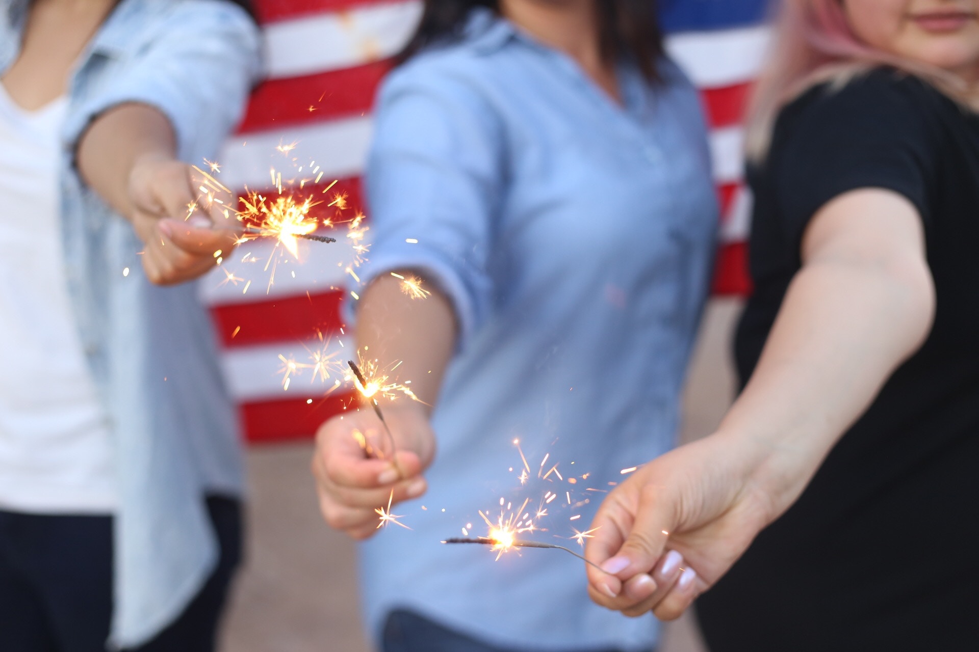 people holiding sparklers - 3 ways how not to blow your diet in one day