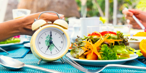 My 60-day Intermittent Fasting Experience - a clock and a plate of healthy foods