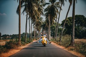 people riding a scooter. heike yates. 