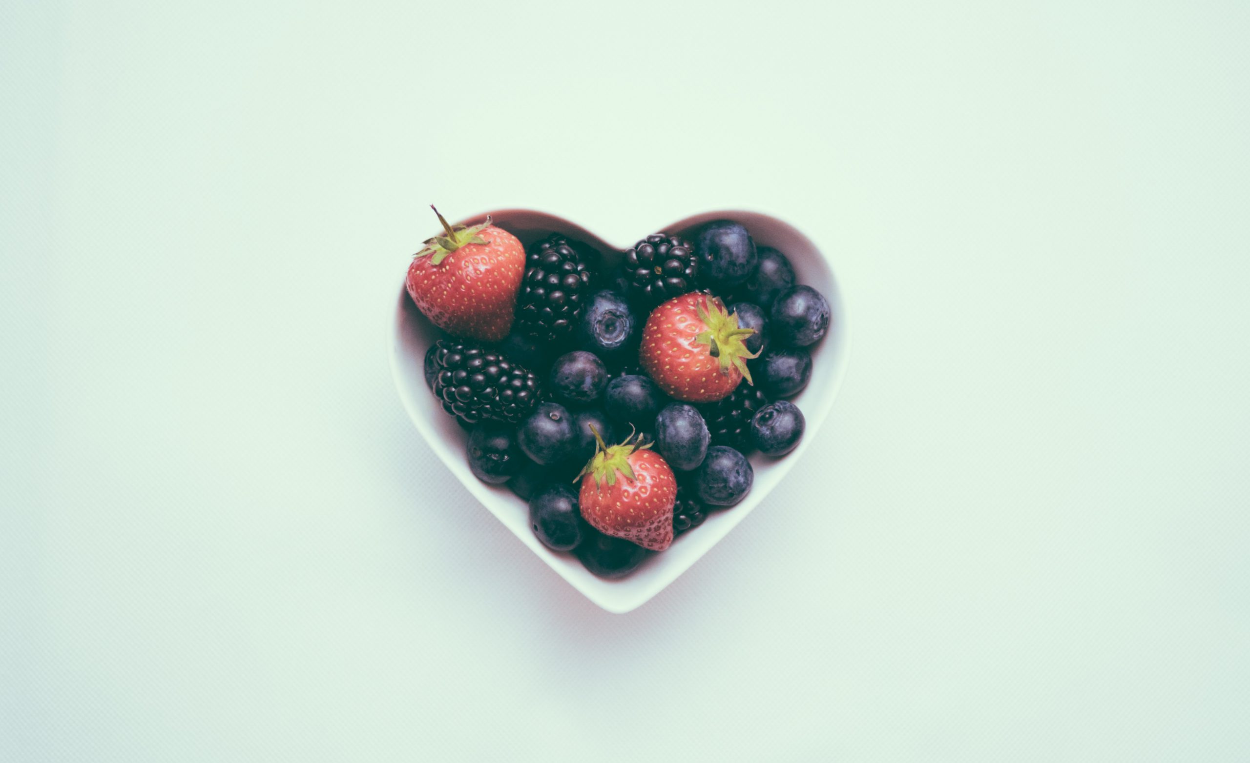 How Intuitive Eating Can Improve Your Healthy Habits. a heart bowl with fruits
