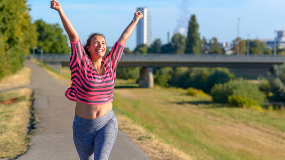 woman celebrating triumphantly whilst running - how to develop self-accountability