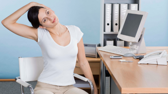 woman stretching at the office -5 Ways To Be Healthier At Work