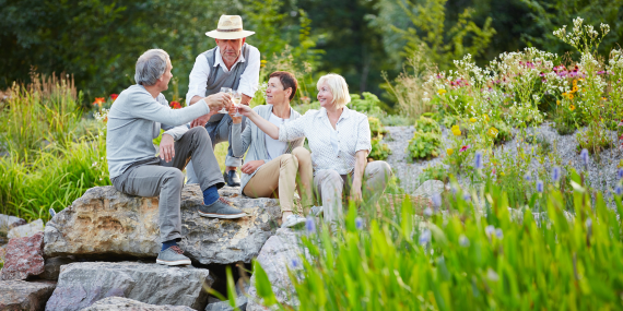 couples out in a field drinking wine and relaxing to create balance in life. 