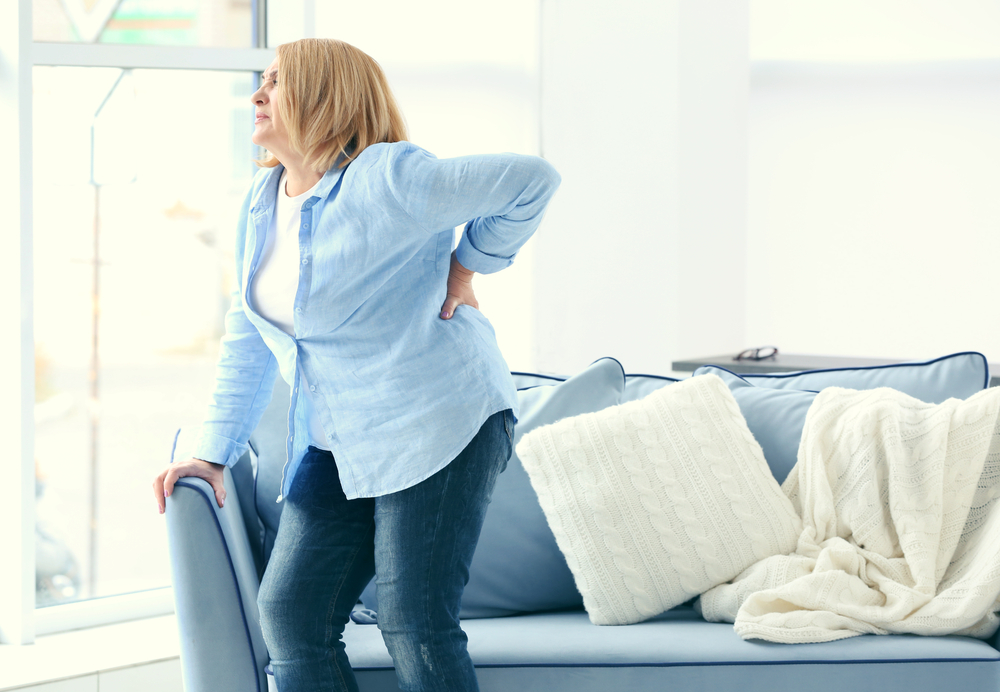 woman with back pain. How To Prevent And Relieve Back Pain