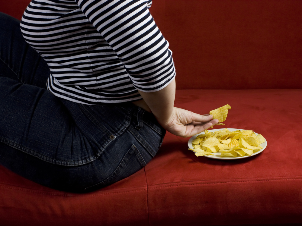 falling off the diet wagon - woman hiding chips - heikeyates.com