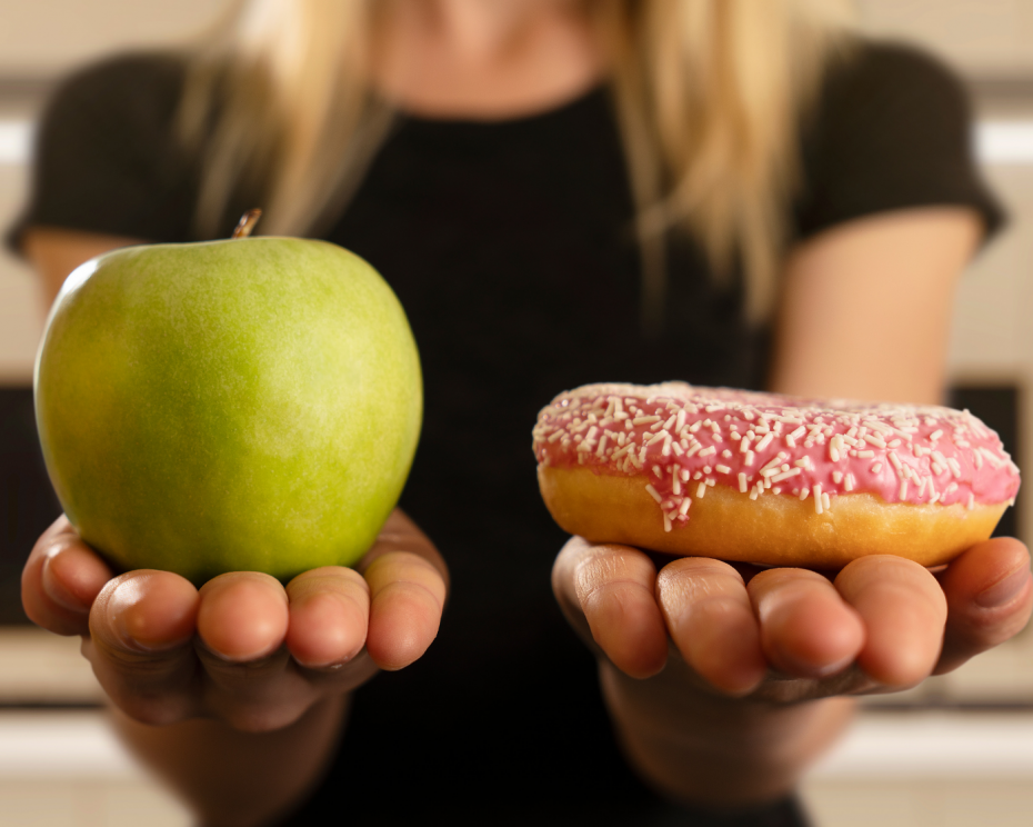 Woman choosing between cravings or healthy food - 5 ways to stop cravings that actually work - heike yates