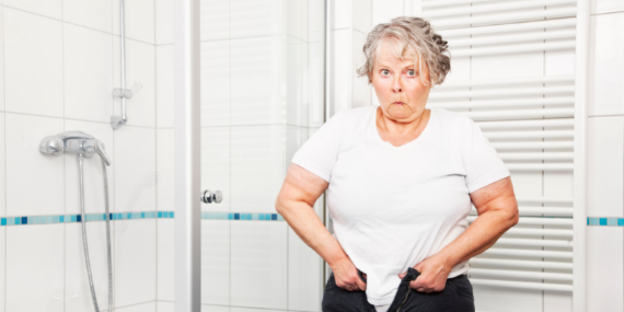 Woman trying on tight pants - 3 tips to manage weight gain after the pandemic - heike yates
