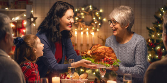 Family eating turkey - Enjoy The Holidays With 5 Easy Intermittent Fasting Strategies - Heike Yates