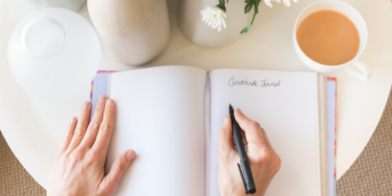hand writing in journal - 5 Small Healthy Habits That You Can Stick With In 2022 - heike yates
