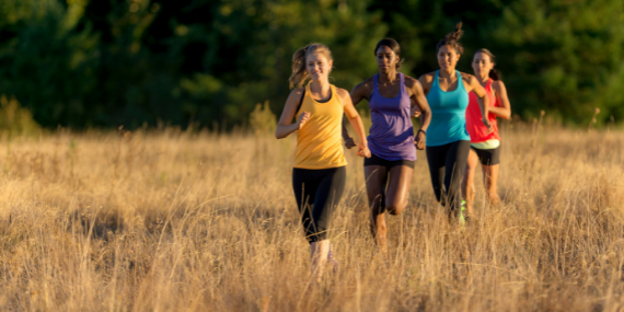 women running in a field - effective ways to stop comparing yourself to other women - Heike yates
