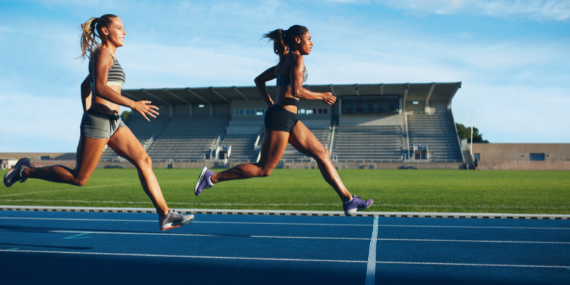 two women sprinting - effective ways to stop comparing yourself to other women - Heike yates
