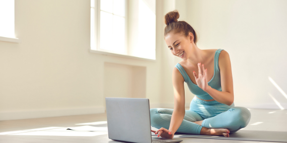 woman sitting in front of laptop - 5 Reasons To Consider Hiring A Fitness Coach - Heike yates