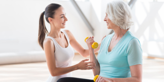 woman coaching another woman - 5 Reasons To Consider Hiring A Fitness Coach - Heike yates