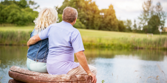 couple sitting by the water - 5 Strategies To Help You To Get Unstuck In Your Empty Nest - heike yates