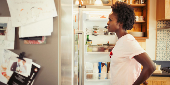 woman in front of a refrigerator - 5 Simple Steps To Spring Clean Your Nutrition Habits. Heike Yates