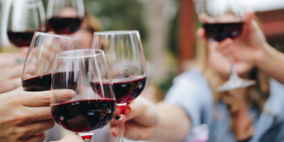 hands toasting with red wine - 4 Easy Ways To Improve Your Diet and Eat Healthily - heike yates