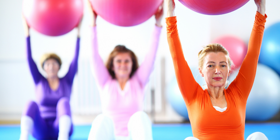 3 Compelling Reasons To Start Pilates Over 50 And Make It A Habit - women holding big ball