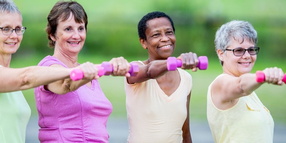 4 Health Benefits Of Protein For Women Over 50 - women holding up weights