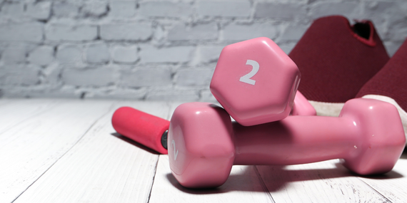 4 Health Benefits Of Protein For Women Over 50 - pink weights stacked