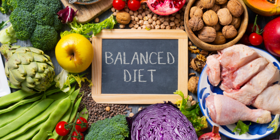 healthy foods and a sign saying balanced diet -10 Age-Defying Fitness and Nutrition Tips for Postmenopausal Women