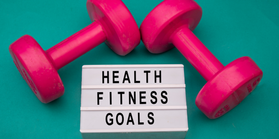 3 Ways To Recapture Your Health and Thrive In Midlife - weights and a sign saying health, fitness, goals