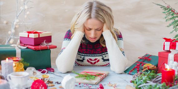 7 Ways To Fight The Holiday Stress -  woman stressing over wrapping presents