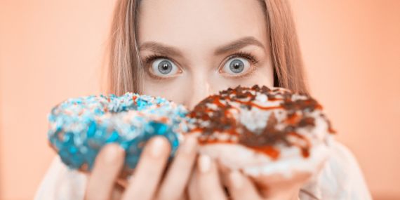 How To Crush Your Sugar Crush To Shrink Your Muffin Top - woman starring at two donuts