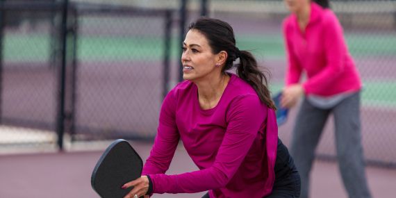 woman playing pickle ball - 6 Powerful Ways to Boost Your Midlife Wellness