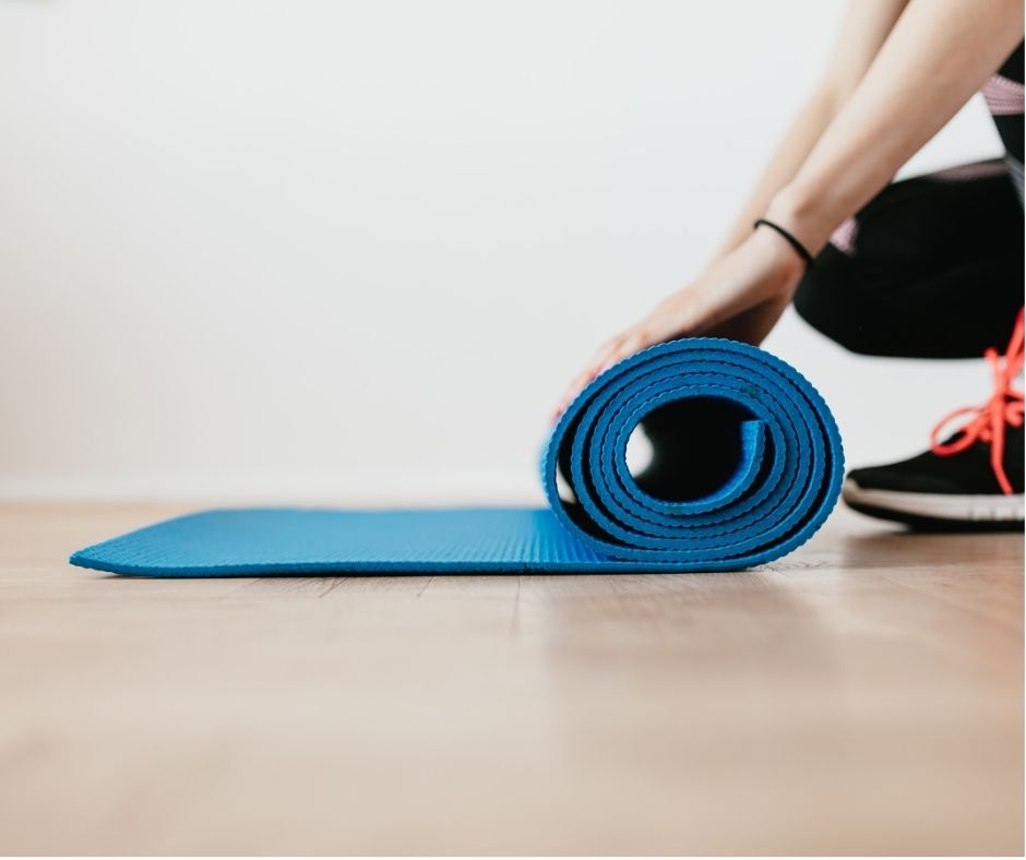 Fasted + Fit Over 50 Jump Start  - yoga mat being rolled up