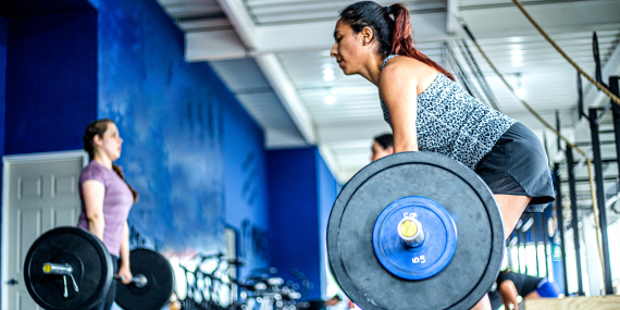 5 Essential Bone Health Strategies In Midlife - women lifting weights in the gym