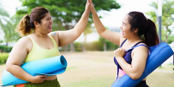 Longevity Lessons From The Blue Zones - women giving high 5 after a class