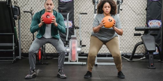 people working out in the gym with a medicine ball