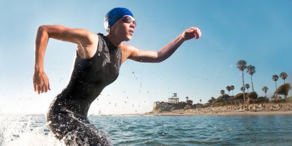 athlete coming out of the water in wetsuit -  8 Reasons To Change Your Workout After 40