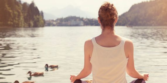 Finding Strength When We Can’t Control the Chaos - woman meditating on a lake with ducks