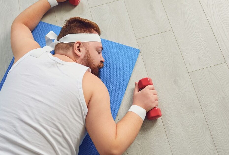 The 3 Biggest Energy Leaks Leading to Midlife Fatigue, man exhaused with weights on floor, energy leak , midlife,
