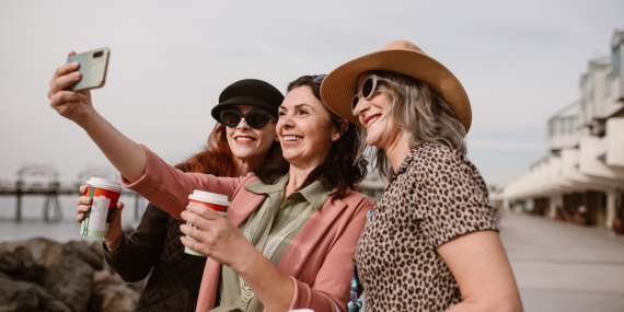 three women taking a selfie on travels, Why a “Midlife Crisis” Isn’t the End—It’s Your New Beginning. midlife purpose