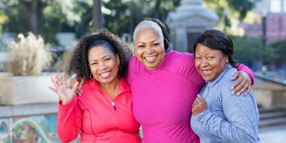 Three women standing and hugging each other. Finding Your Purpose: How to Build Confidence and Stop Feeling Invisible. midlife women, fitness,