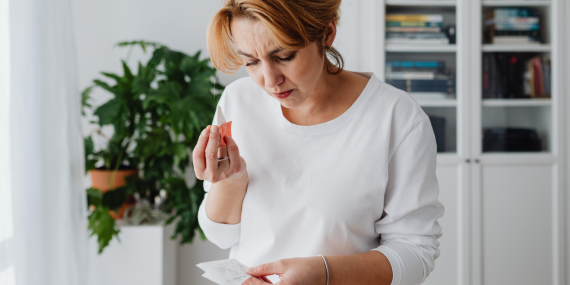 3 Ways To Stop Overthinking Everything in Midlife - woman frustrated looking at notes