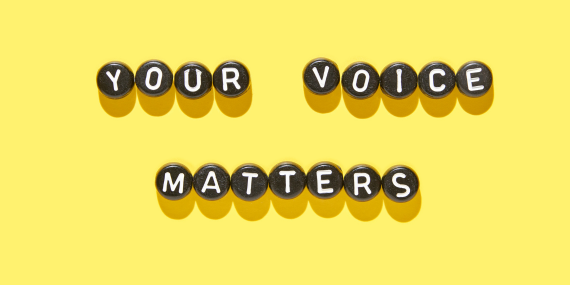 a yellow sign saying your voice matters
