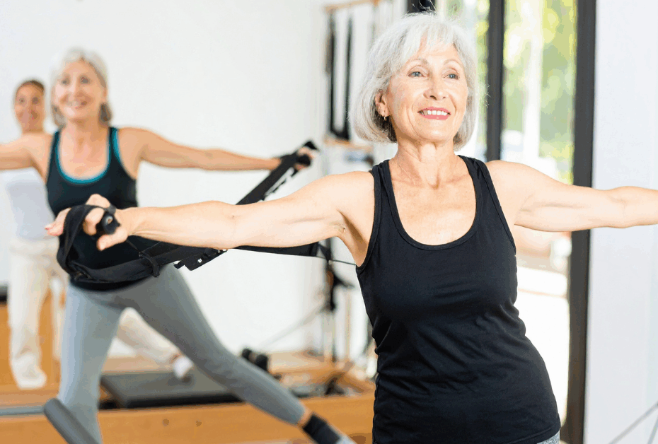 midlife women doing Pilates in a studio on the reformer