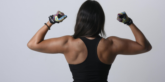 midlife woman showing off her back muscles for strength