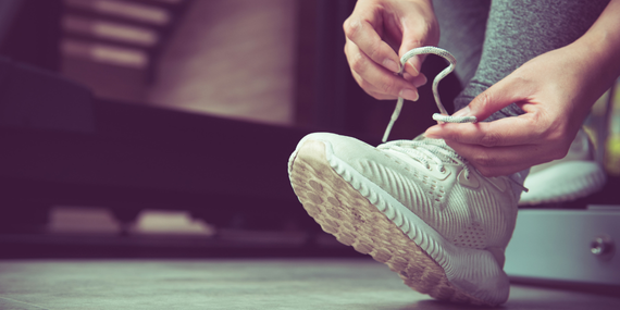 someone tying a tennis shoe