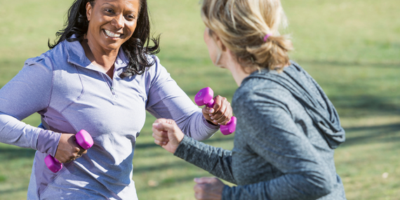 Staying Consistent in Midlife: Why Old Habits Stop Working—and What to Do Instead, two women lifting weights outside