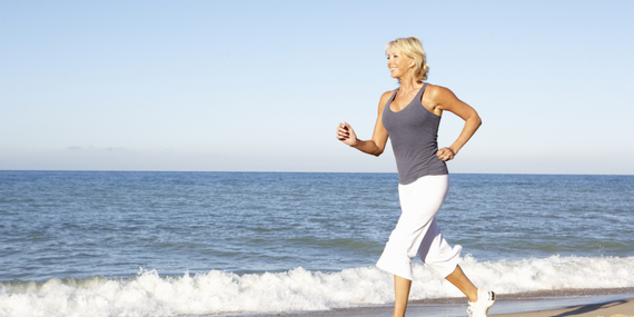 When Familiar Midlife Fitness Habits Stop Working. Woman running on the beach.