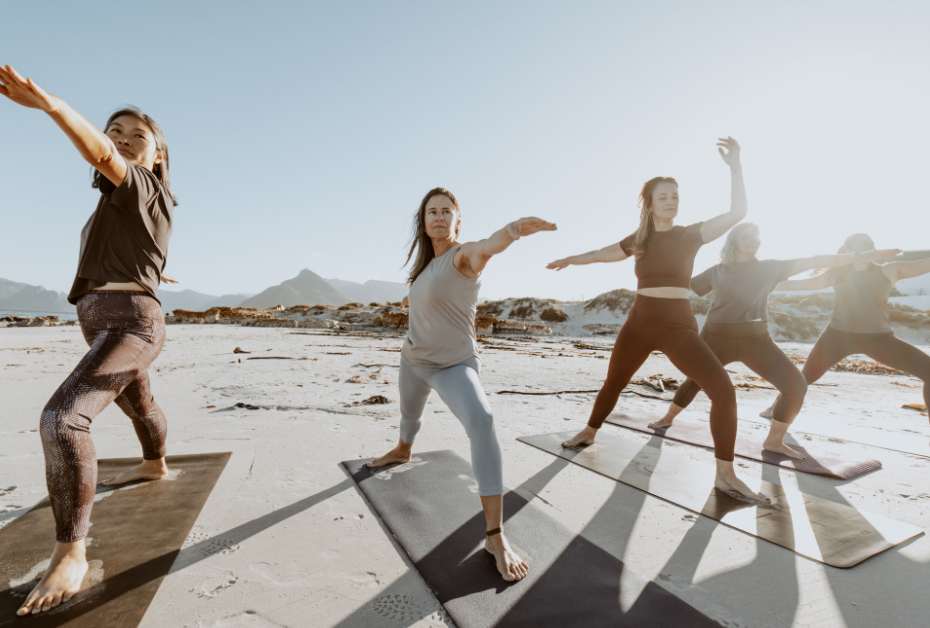 Fitness in midlife . women stretching in a straight line outdoors