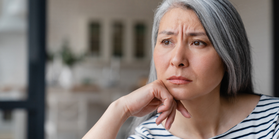 Midlife woman frowning because she feels stuck in her fitness routine